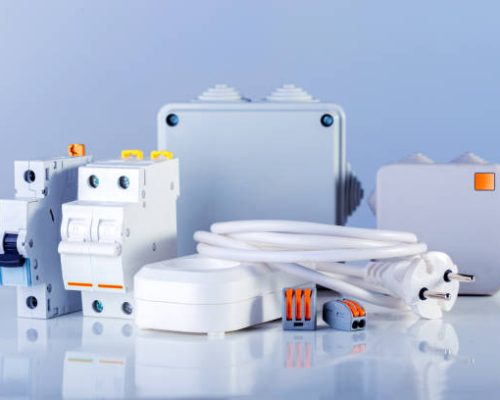 Different electrical equipment on blue background.  Various electric products on the store shelve.